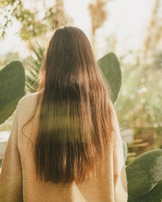 Long brown hair from behind in a garden